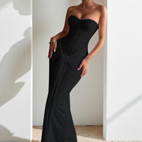 Evening dress with a long skirt that cinches at the waist to show off a slender figure