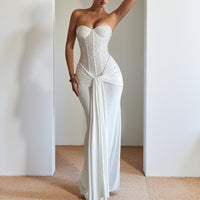 Evening dress with a long skirt that cinches at the waist to show off a slender figure
